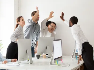 A work team all giving a group high-five
